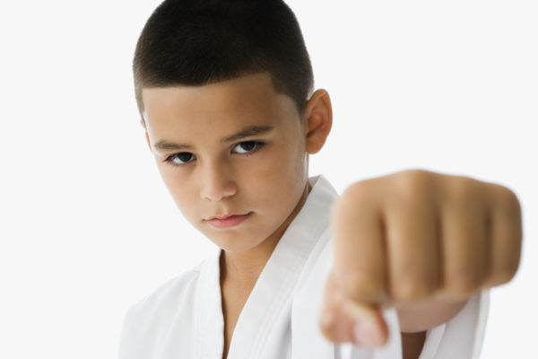 Studio shot of Hispanic boy in martial arts stance